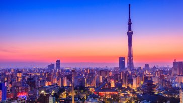 The sun rises over the city of Tokyo in the morning